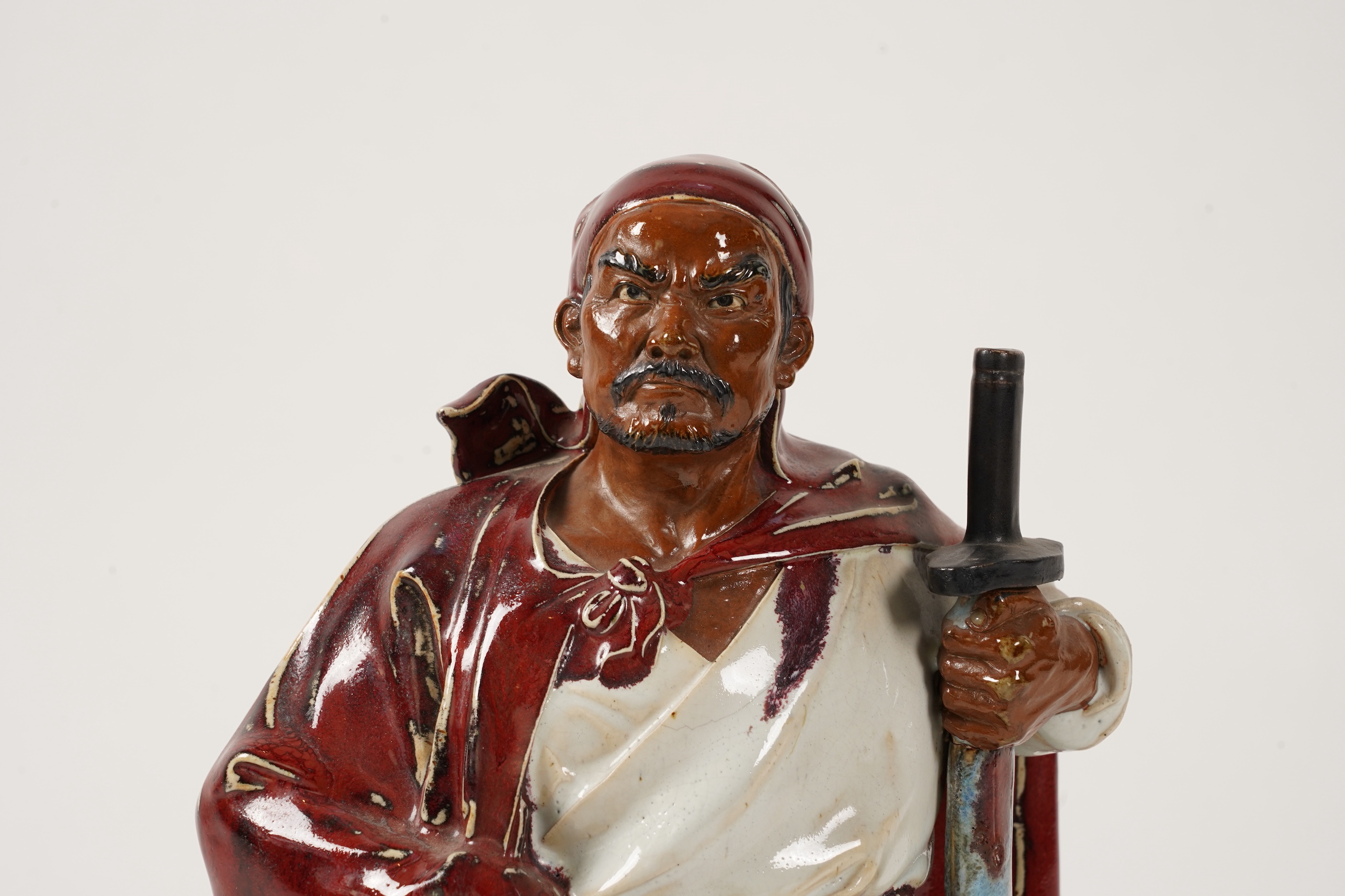 A large Chinese Shiwan stoneware figure of a warrior, 20th century